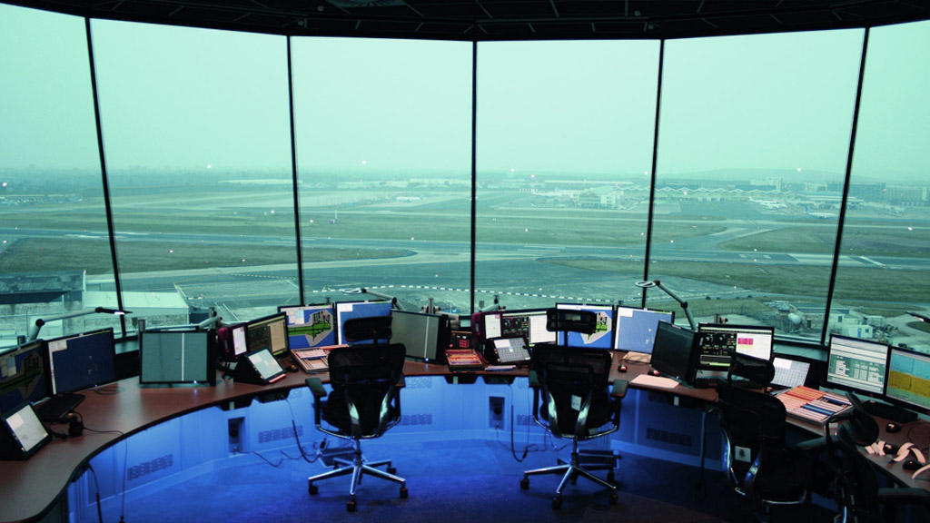 airport mission control room with consoles, monitors and chairs